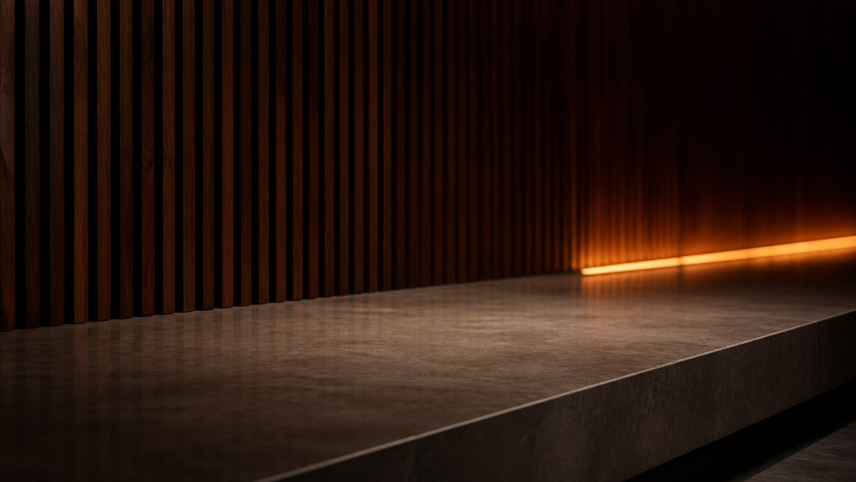 A dark fluted walnut wall with one warm light strip