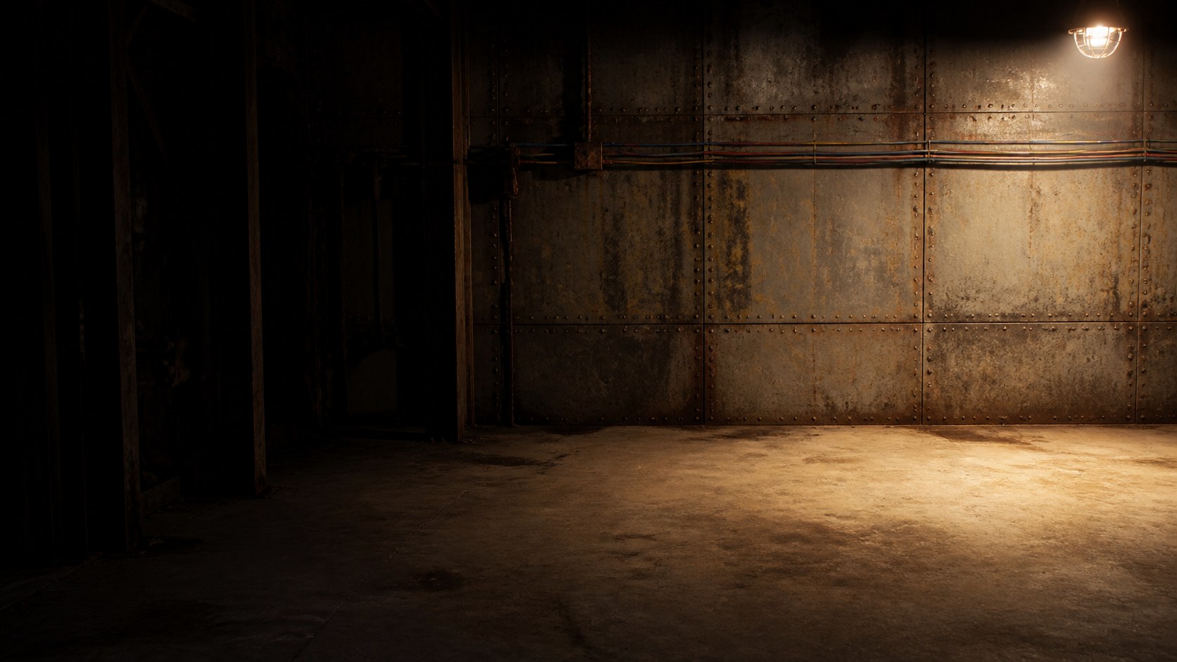 A disused workshop, one caged lamp at the upper right