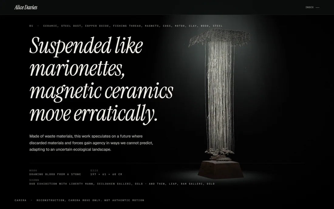 A tall woven canopy with fine threads falling to a small base, lit in the dark, with the work's title and materials set in the left column