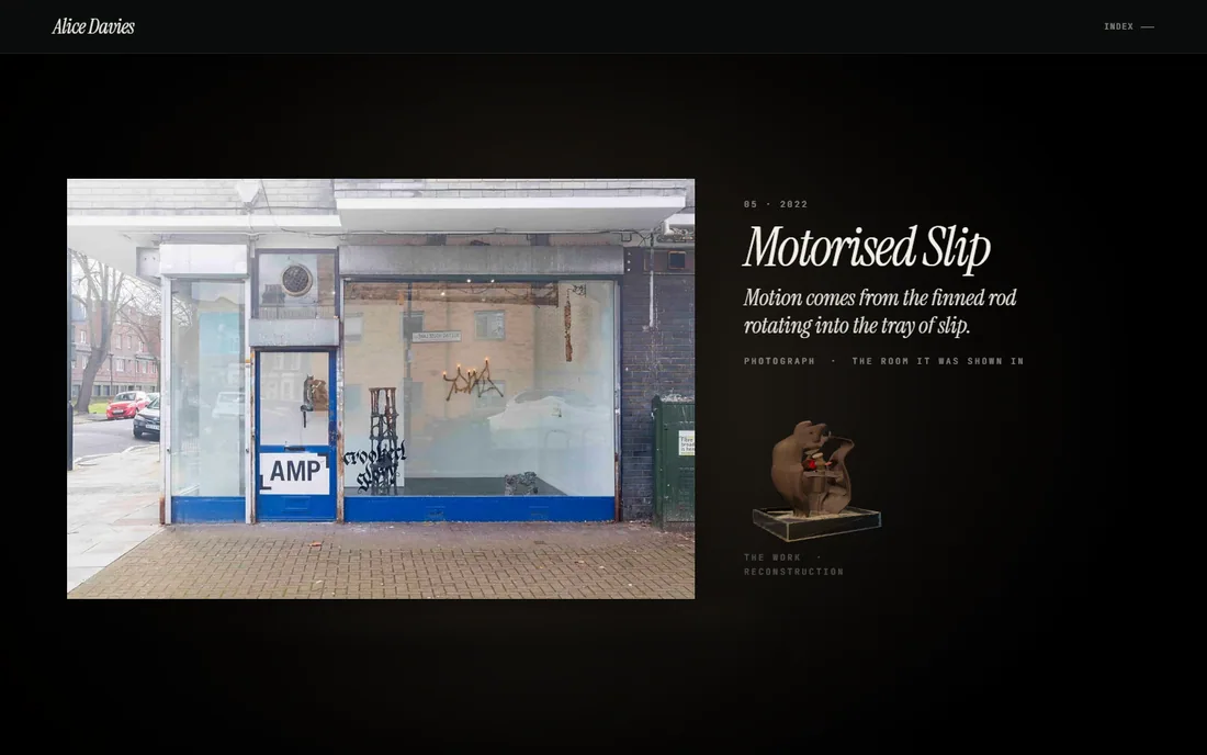 A Peckham shopfront photographed from the street: painted windows, the gallery name taped to the door, a branch hung with candles behind the glass