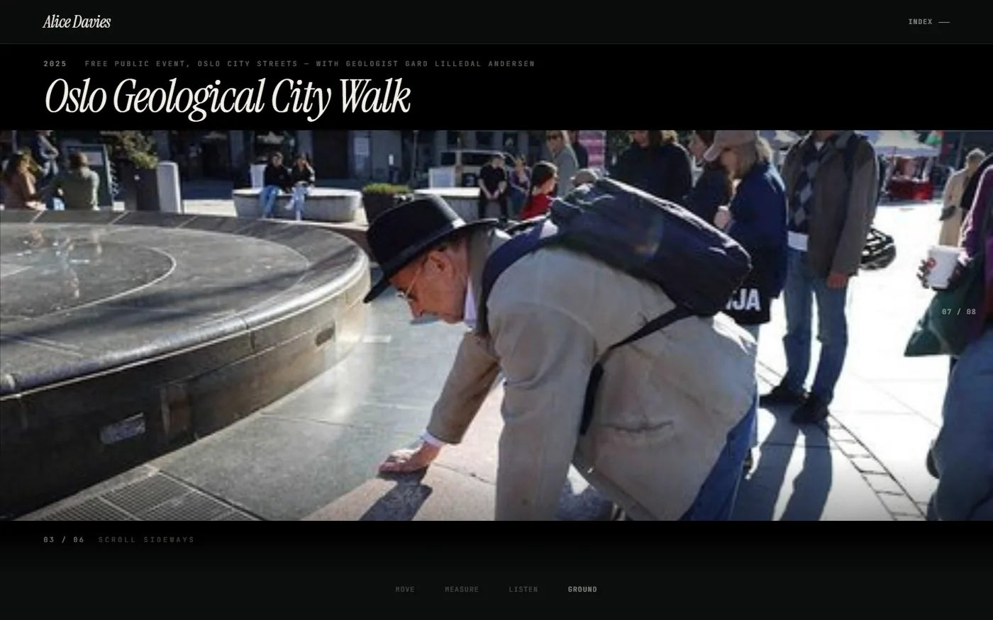A full-screen photograph from the walk: a person in a hat crouching to touch the polished stone rim of a city fountain while the group stands behind