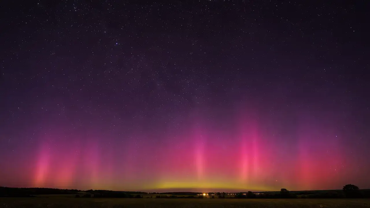 A night sky of magenta and coral light with no horizon in frame