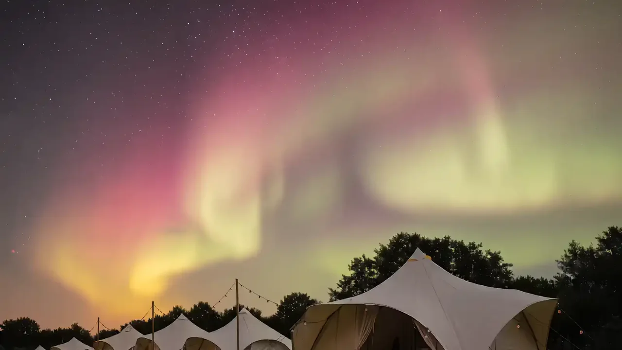 The same sky with a treeline appearing at the base of the frame