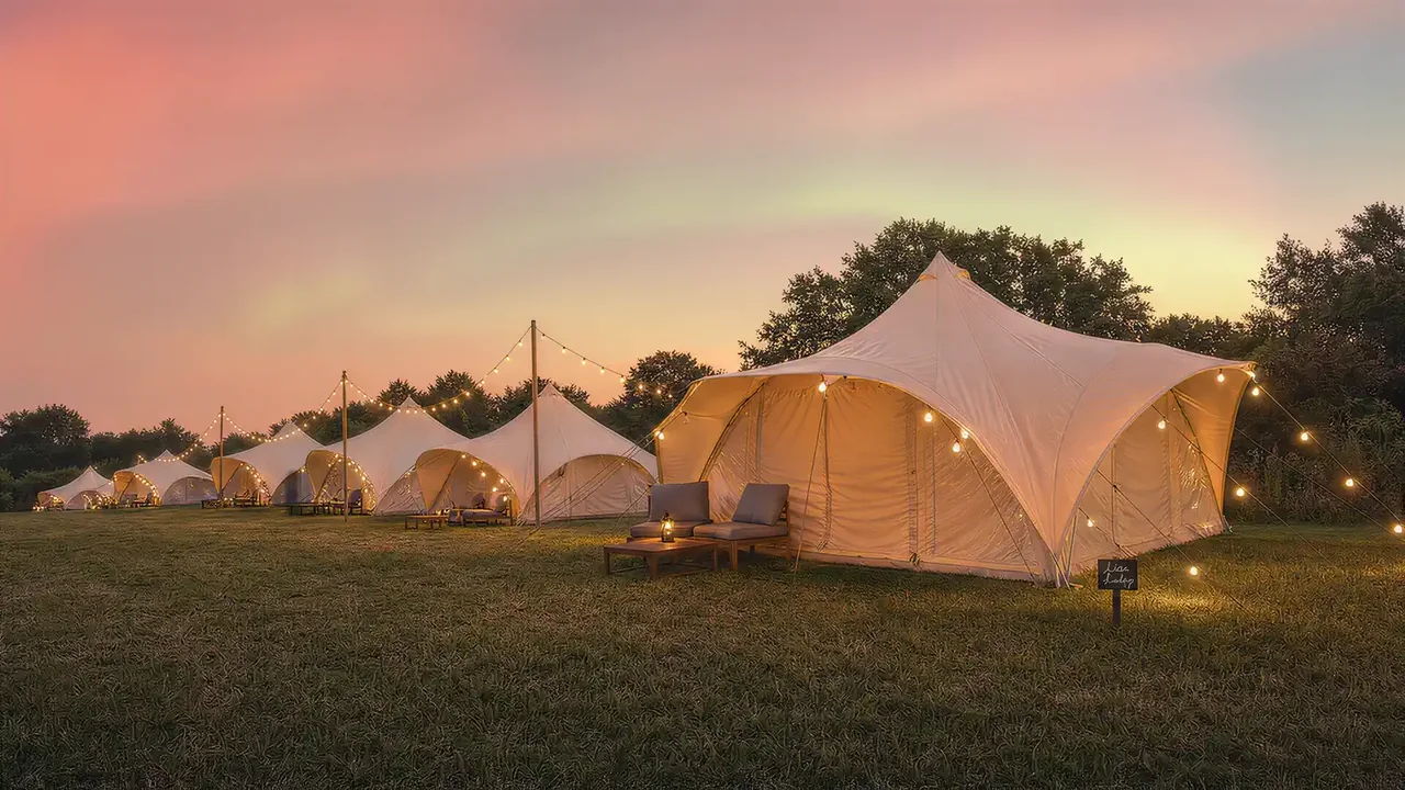 The full field of tents at dusk