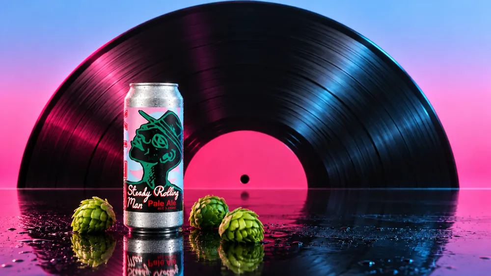 The can in front of a giant vinyl record rising like a sun