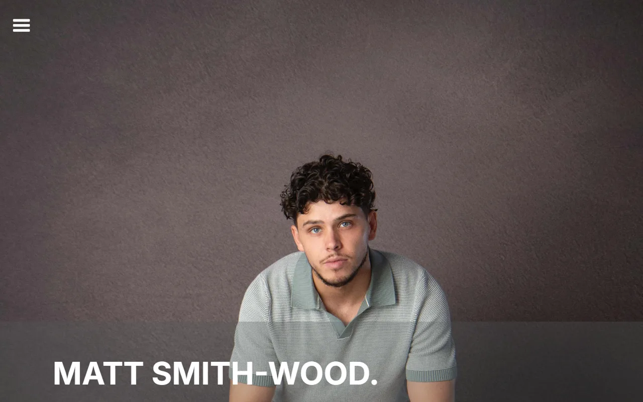 The 2024 homepage: a single menu icon at top left, Matt centred beneath a bare grey wall, his name small along the bottom edge