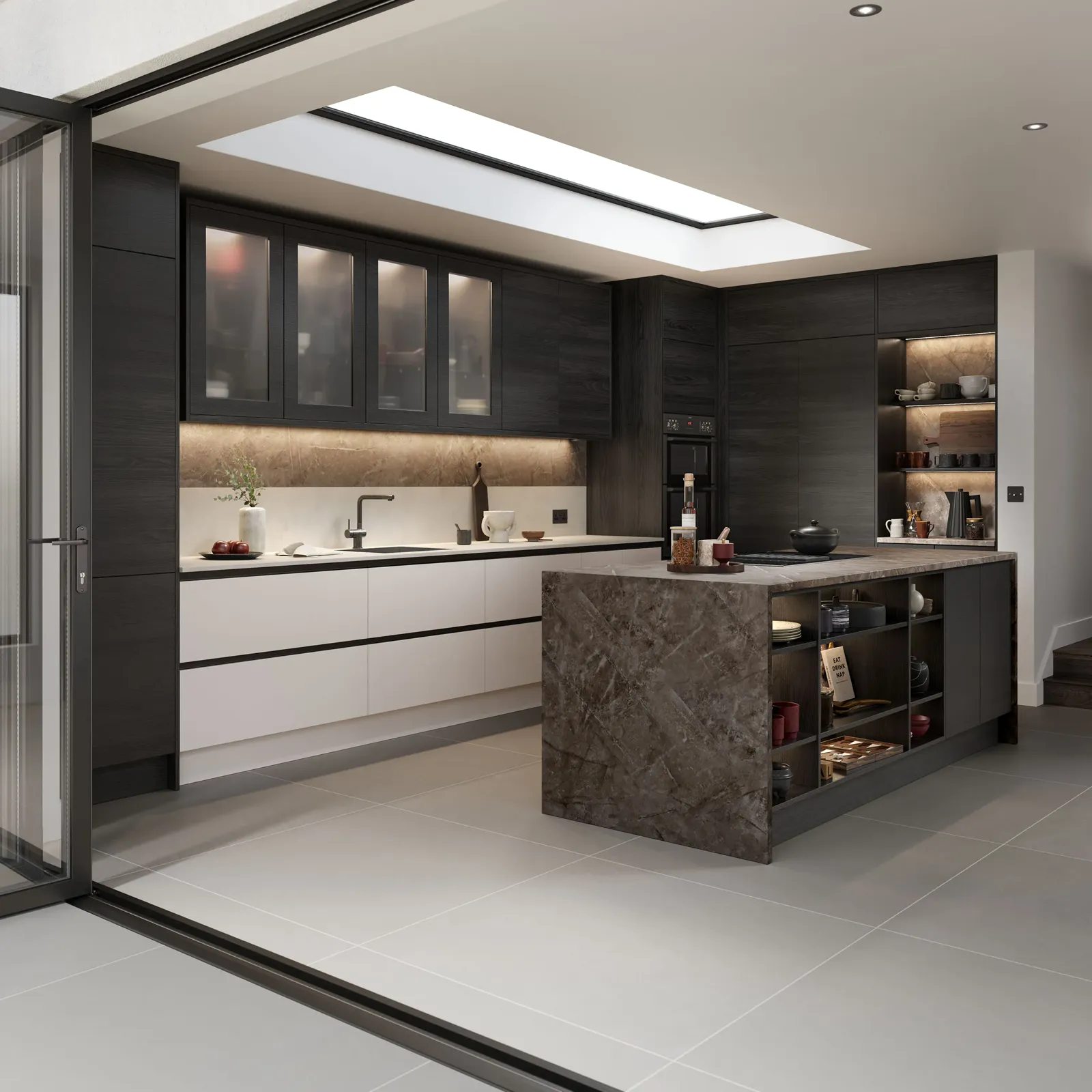 Kitchen with stone island and glazed wall opening to outside