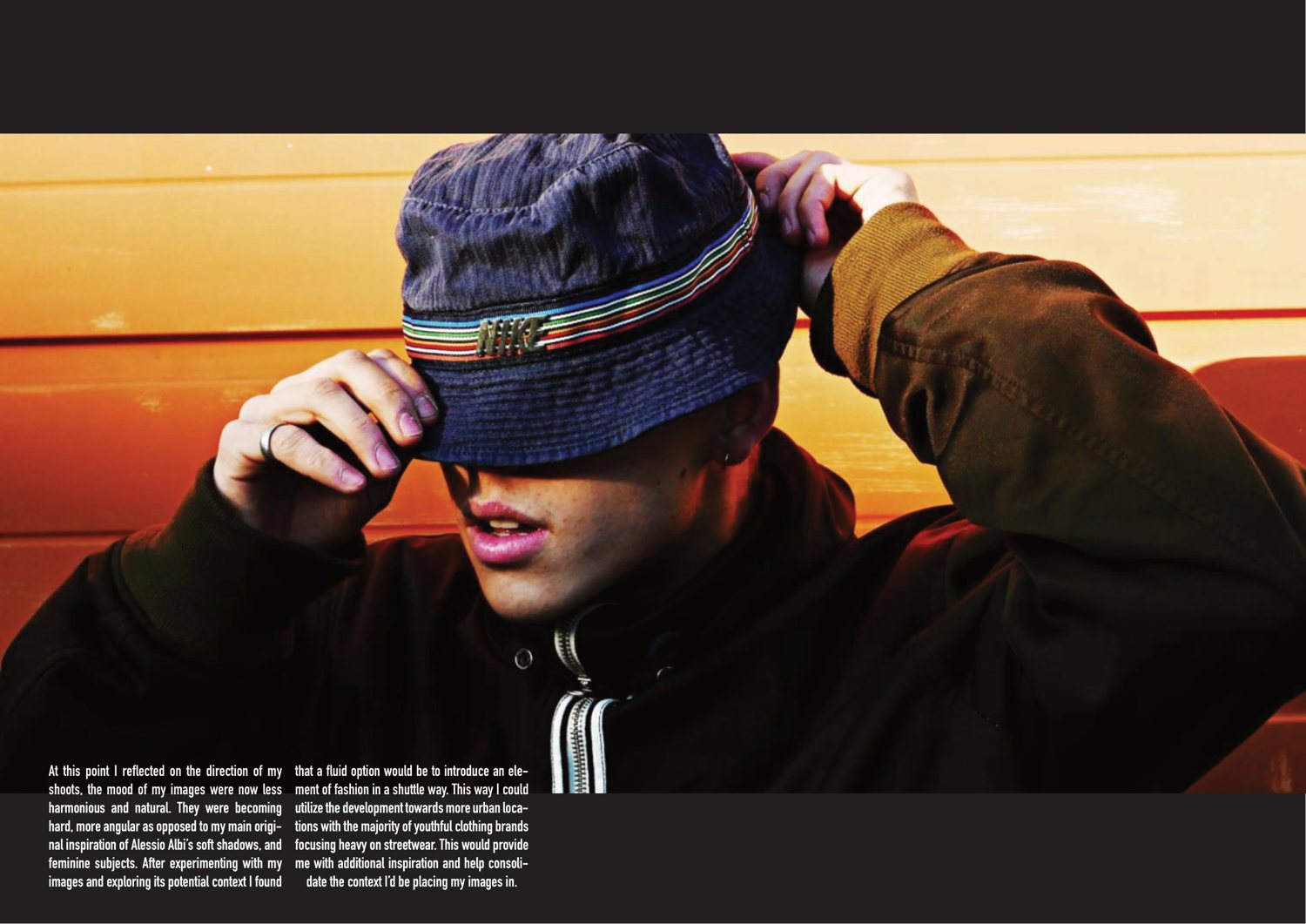 A full-bleed spread of a portrait lit orange, the subject pulling a bucket hat down over his eyes