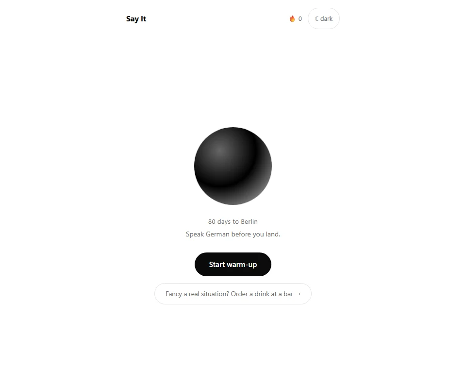 The Say It app: a dark orb centred on a white page, with the line 80 days to Berlin, Speak German before you land, and a Start warm-up button